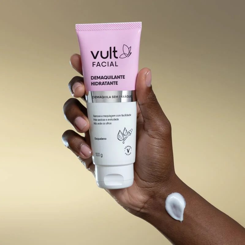 Tubo de Demaquilante Vult Facial Hidratante V2 100g, embalagem branca e rosa, produto cremoso aplicado no dorso da mão